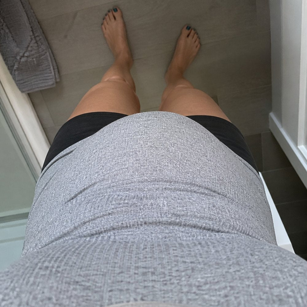 Looking down at her own midsection, lean legs, the stomach in the way